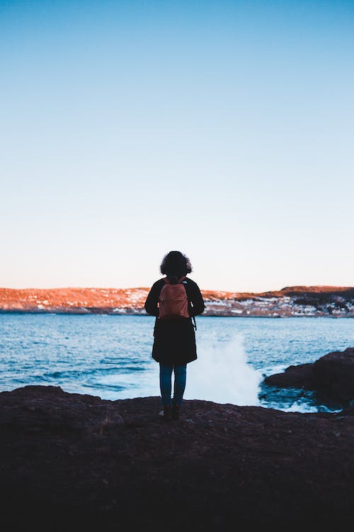 female swimmer with swim backpack in an open water