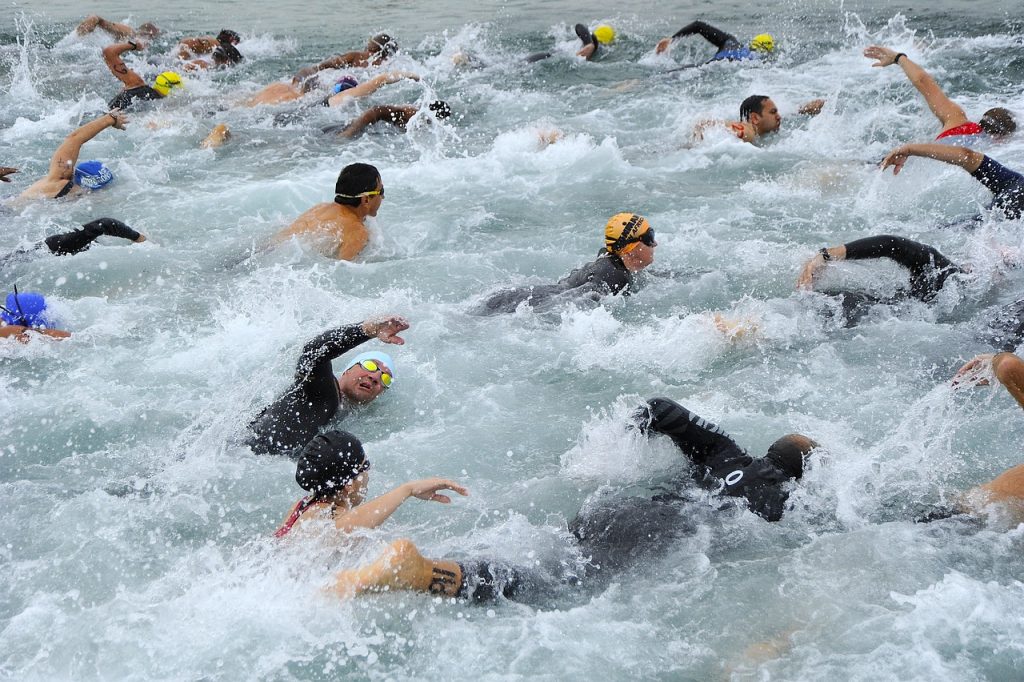 male swimmers competing with their fellow swimmers