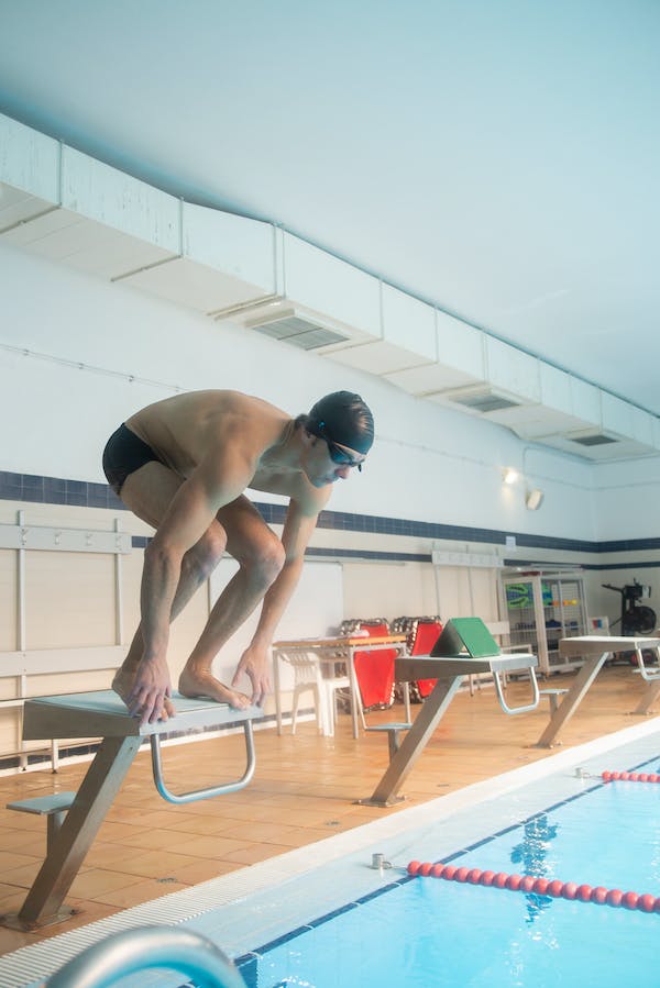 Swimmer diving from the swimming block