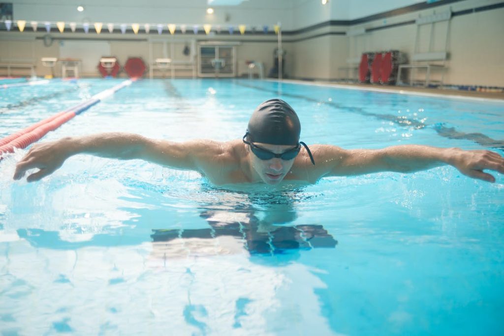 swimmer in the swimmer position performing the butterfly stroke 