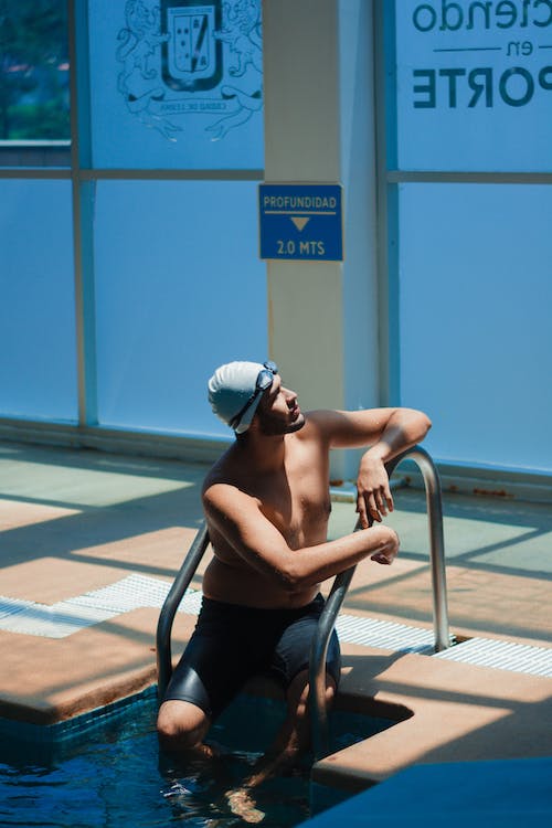 male swimmer tracking his swimming progress on the score board