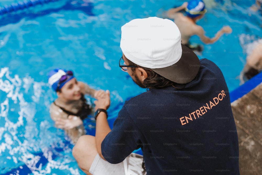 A private swim instructor with his student taking private adult swim lessons