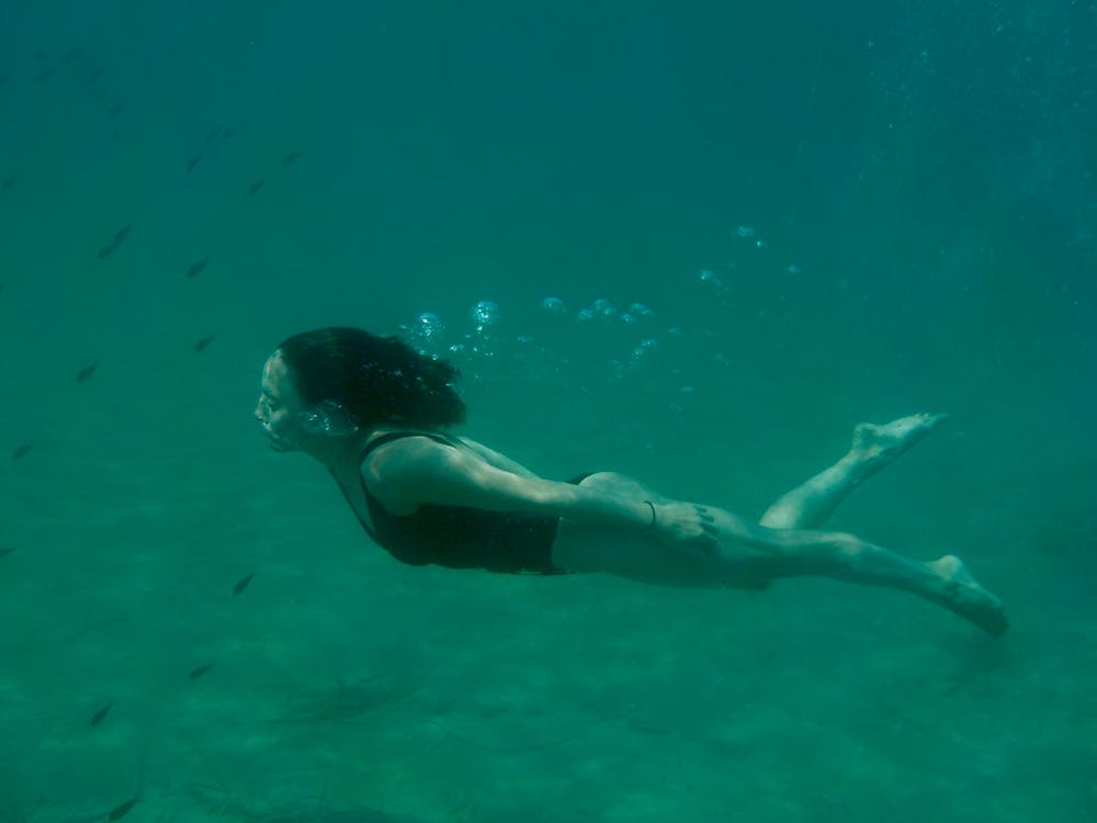 female swimmer practicing breathing under the water