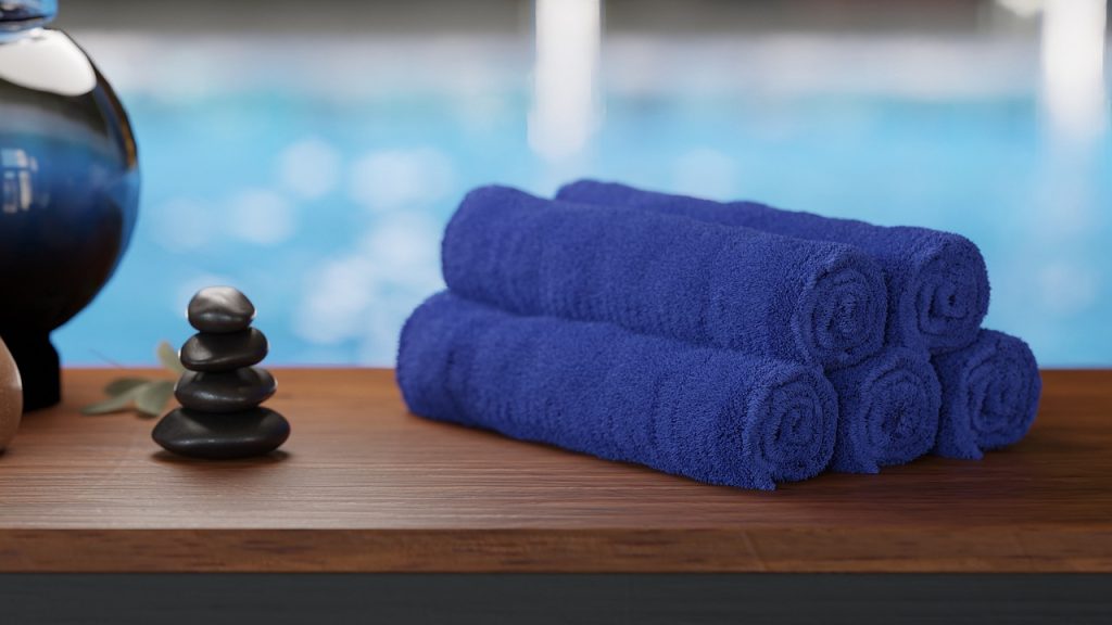 Blue swim towels placed outside the swimming pool area