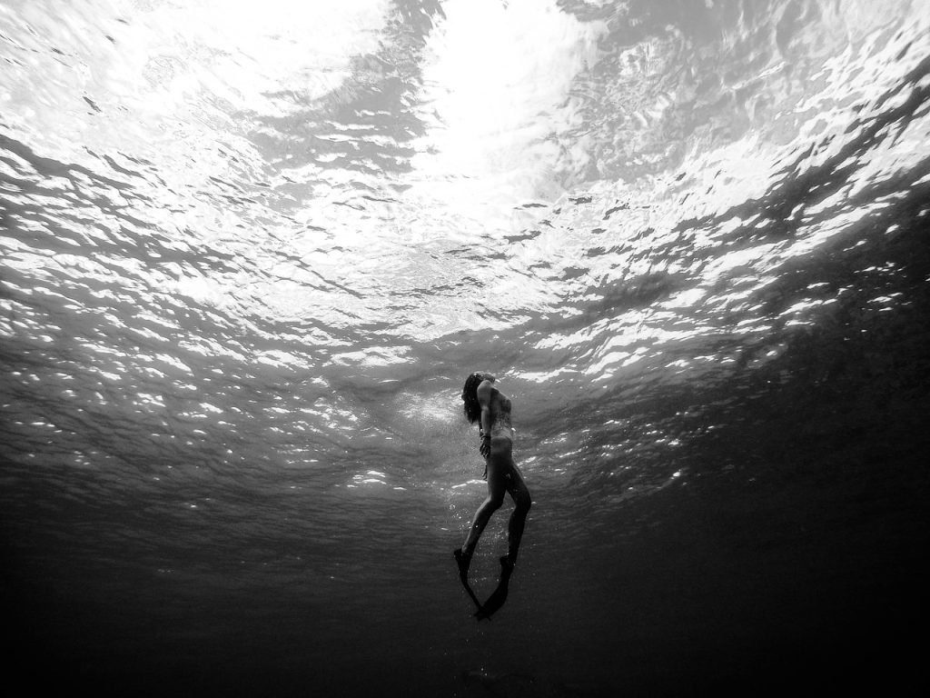 female swimmer swimming with swim fins