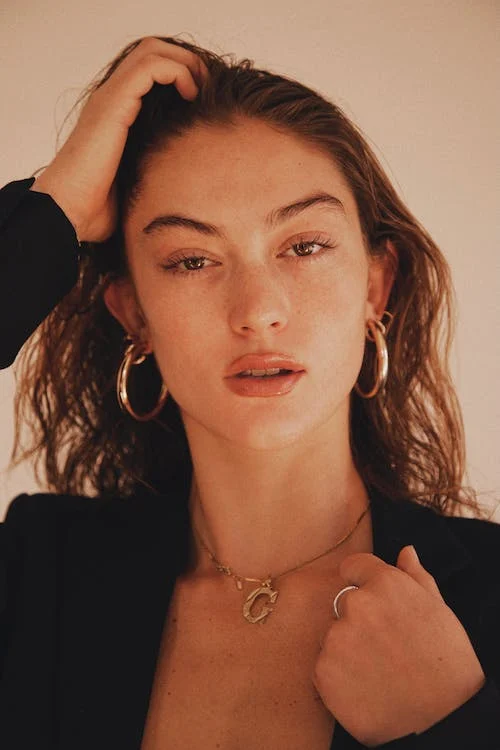 Woman in Black Shirt Wearing Silver Necklace